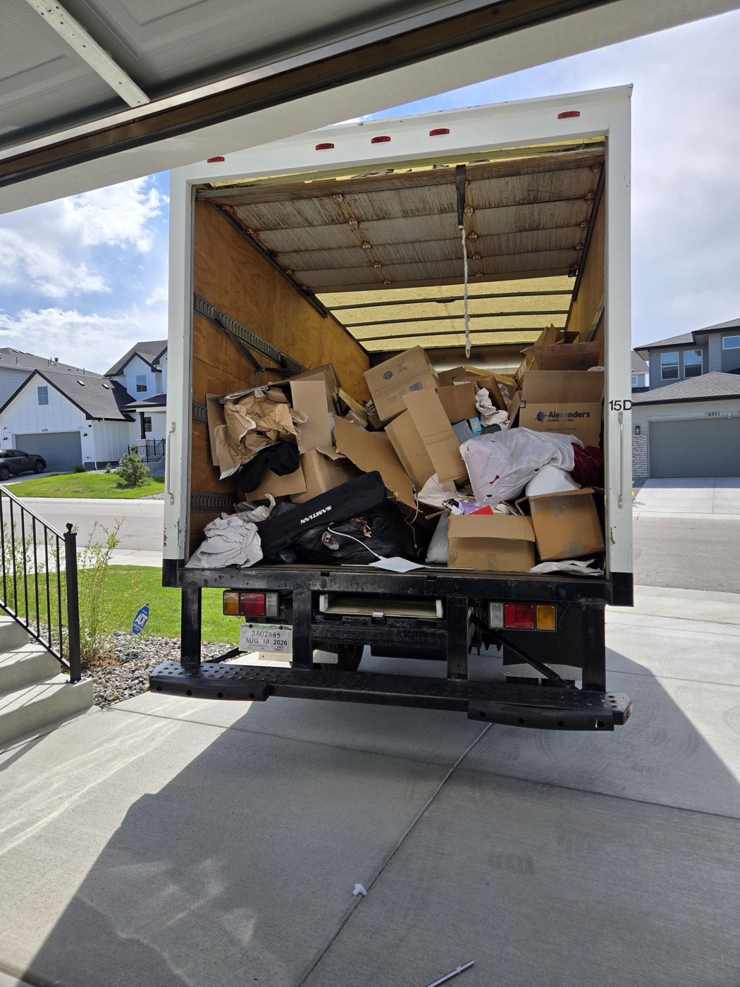 Box truck loaded with boxes and household items at the end of a job